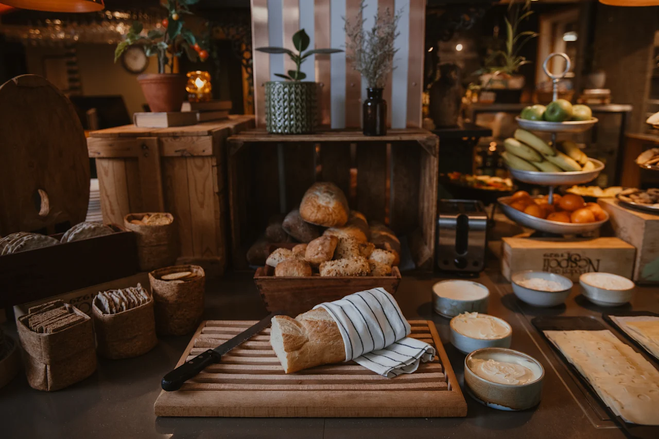 A delightful breakfast buffet at Home Hotel Uppsala, featuring fresh bread, pastries, fruits, and spreads, ready for guests to enjoy.