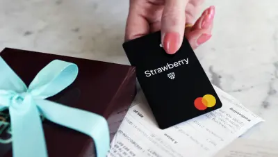 A Strawberry Mastercard, a receipt and a gift box.