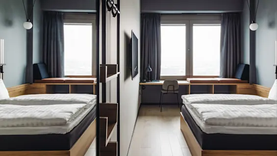 Two neatly made beds face large windows with closed curtains, a desk and chair in between, modern decor and soft lighting in a minimalist hotel room.