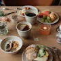 A table laden with a delightful breakfast spread including coffee, tea, juice, pastries, fruit, and savory dishes.