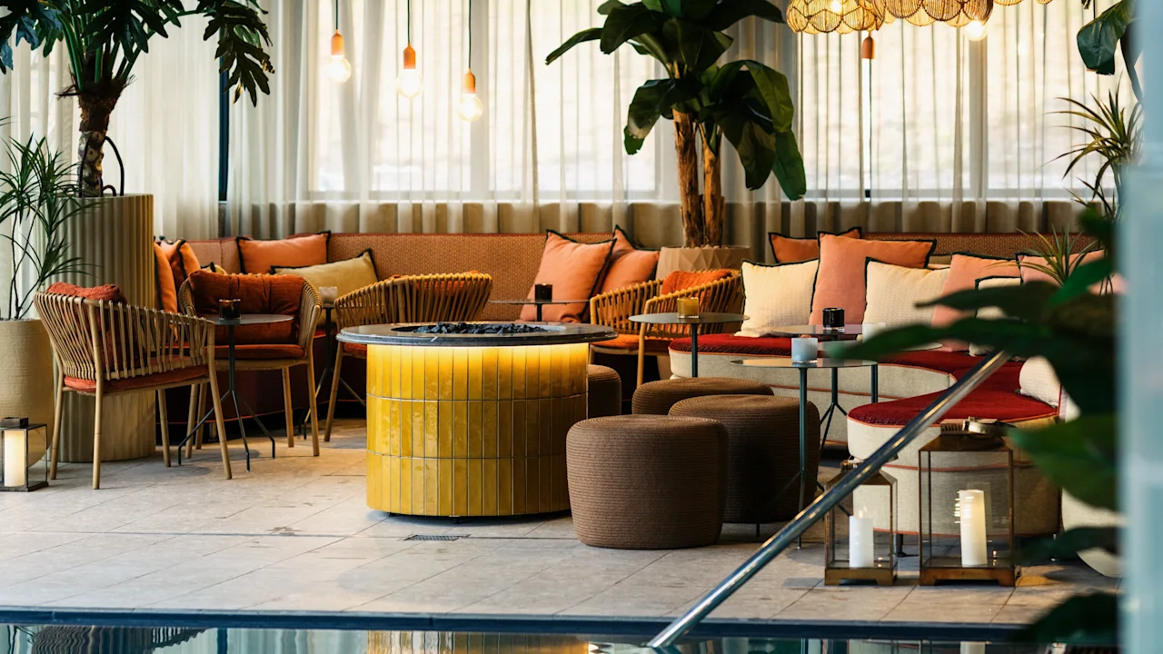 A luxurious indoor pool area at Lily Country Club with a cozy lounge, comfortable seating, and warm lighting.