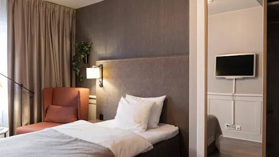 A welcoming hotel room at Home Hotel Grand Bodø, offering a comfortable space for rest and relaxation.
