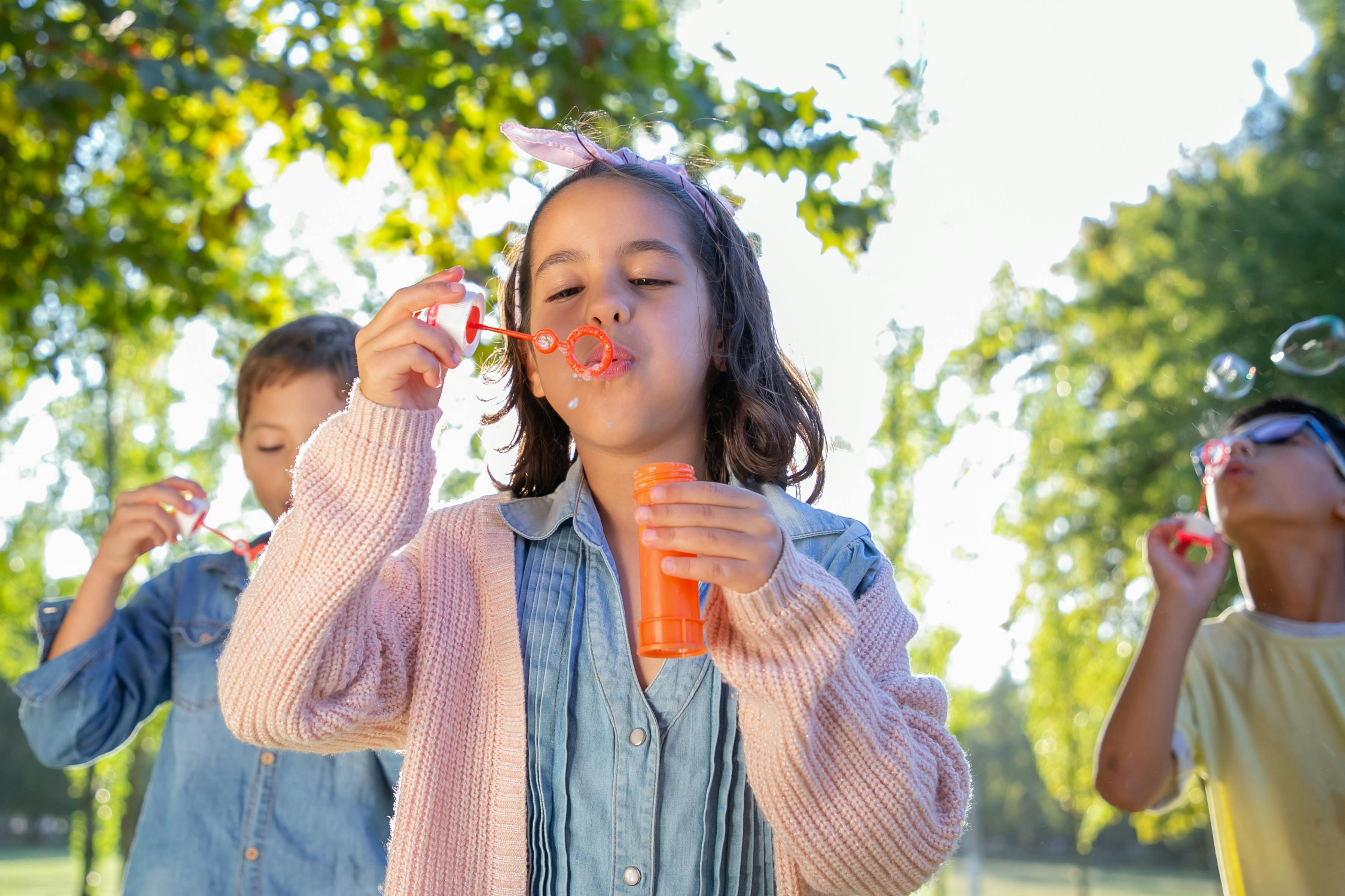 Kids playing outdoor with soap bubbles