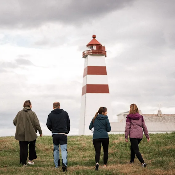 Group walking towards a lighthouse during a Kickoff at Quality Hotel.
