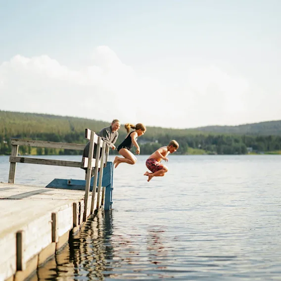 Kids jumping into the water during summer.