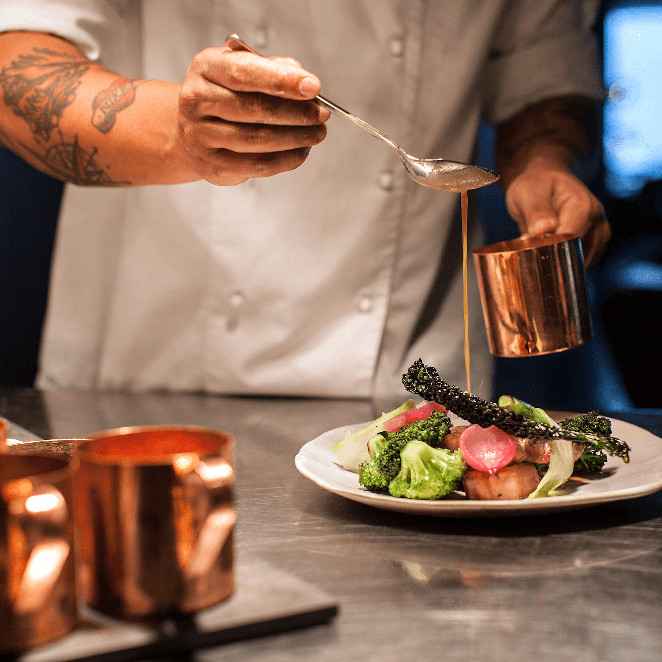 Chef preparing food in the kitchen at Vox Restaurant in Jönköping.