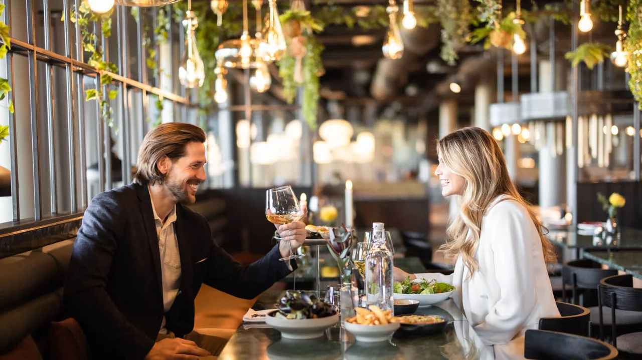  couple toasting in wine glasses at restaurant