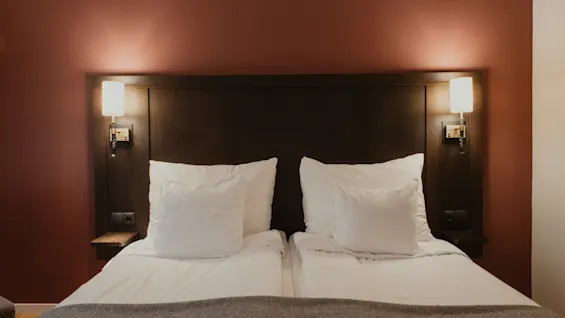 A cozy hotel room at Home Hotel Kung Oscar with a comfortable bed, ready for a relaxing stay.