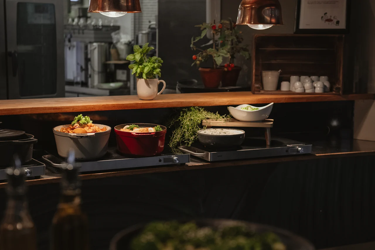 A warm and inviting buffet spread at Home Hotel Uppsala, featuring various delicious dishes ready to be served.