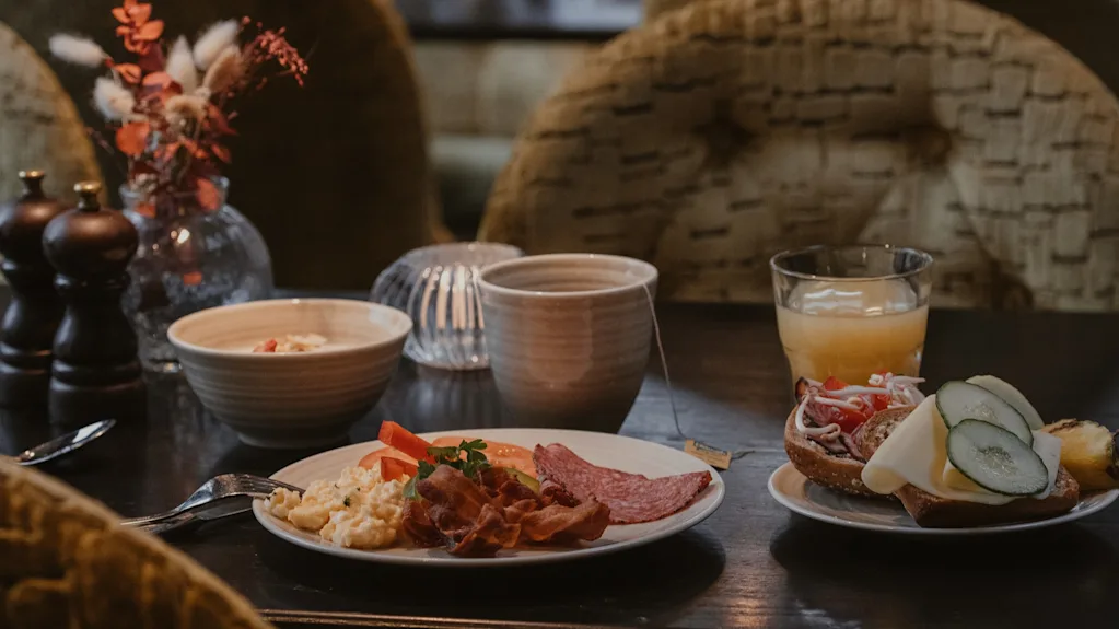 A table laden with a tempting breakfast, including savory and sweet options, at Home Hotel Kung Oscar.