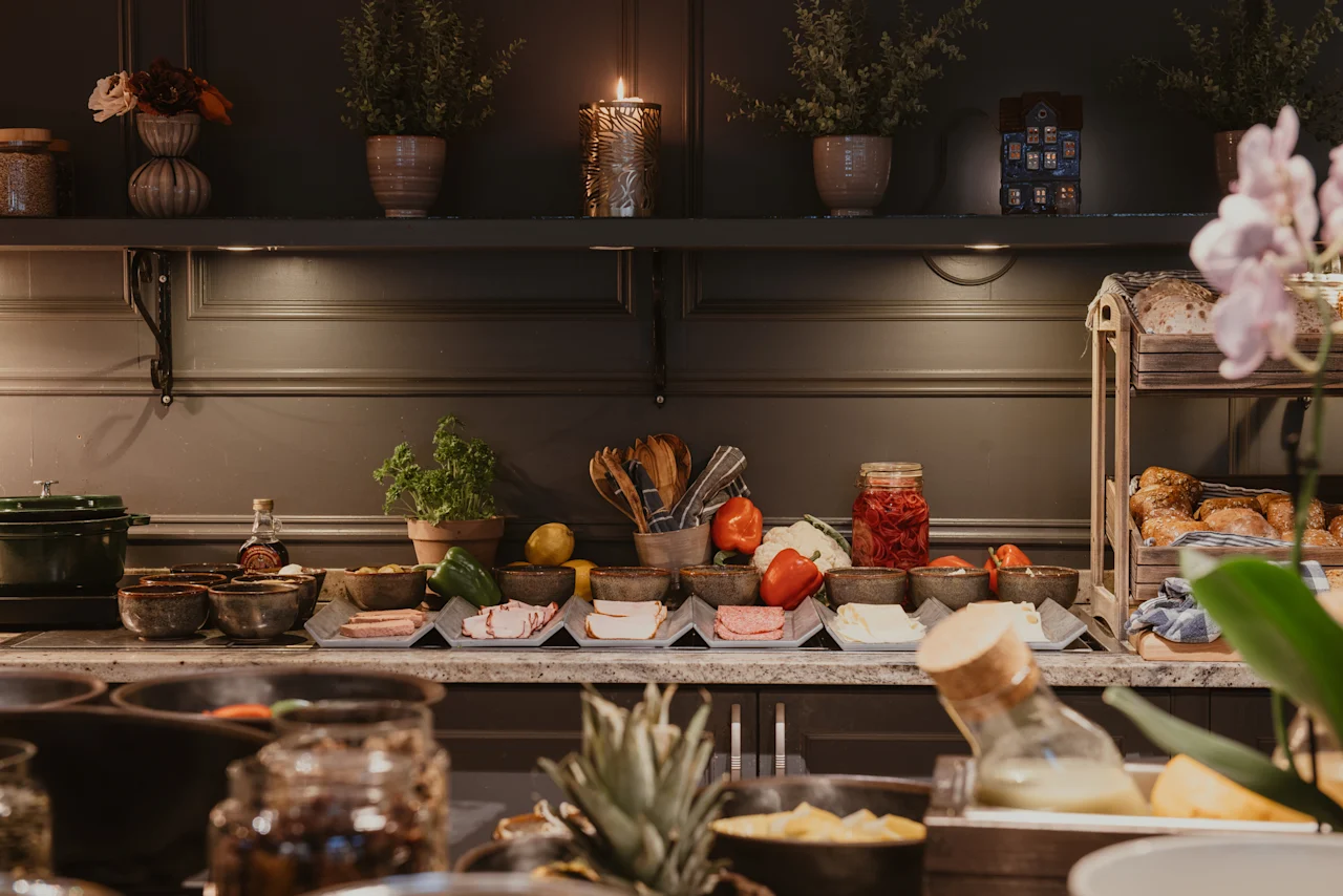 A beautifully arranged buffet spread with fresh ingredients, cold cuts, and bread, ready for guests at Home Hotel Kung Oscar.