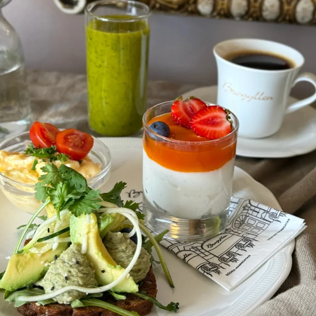 En härlig frukostbricka med avokadomacka, äggröra, fruktyoghurt, grön smoothie och kaffe. Bryggarallen Vastra Hamngatan Sodra Hamngatan