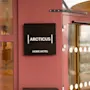 A hotel entrance featuring a sign with the words ARCTICUS HOME HOTEL.