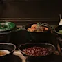 A warm buffet at Home Hotel Kung Oscar featuring hearty dishes like meatballs, peas, and berry sauce, ready to be served.