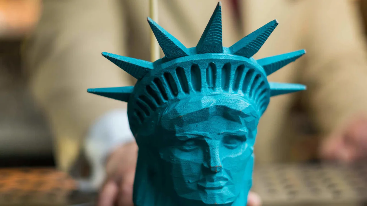 A drink served in a glass shaped like the Statue of Liberty.