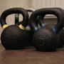Kettlebells and other fitness equipment on the floor, ready for a workout at Home Hotel Kung Oscar.