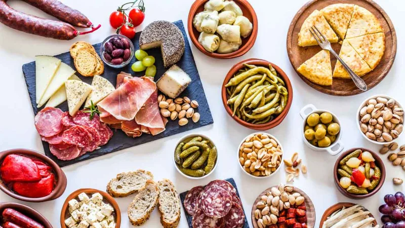 Tapas food sharing platter white background