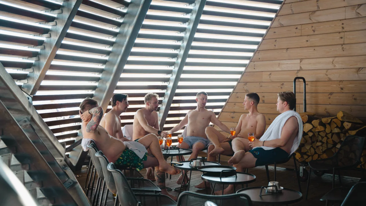 A group of friends having fun before outside of a sauna in Helsinki.