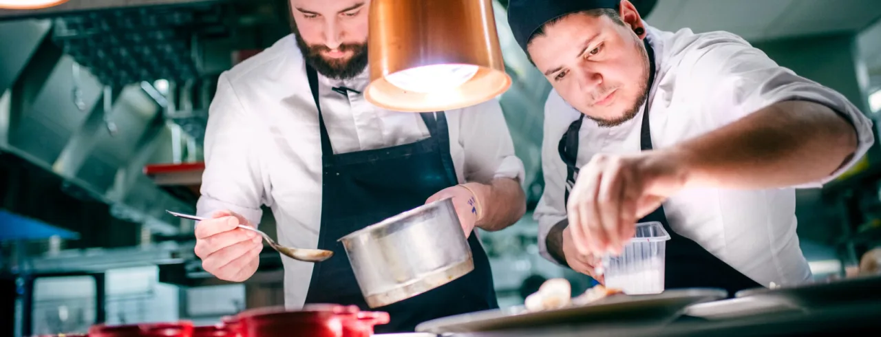 Two chefs plating at Restaurant Niesti at Copperhil Mountain Lodge in Åre.