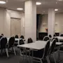 Konferensrum med flera bord och stolar arrangerade för ett möte eller evenemang på Home Hotel Grand, Helsingborg.