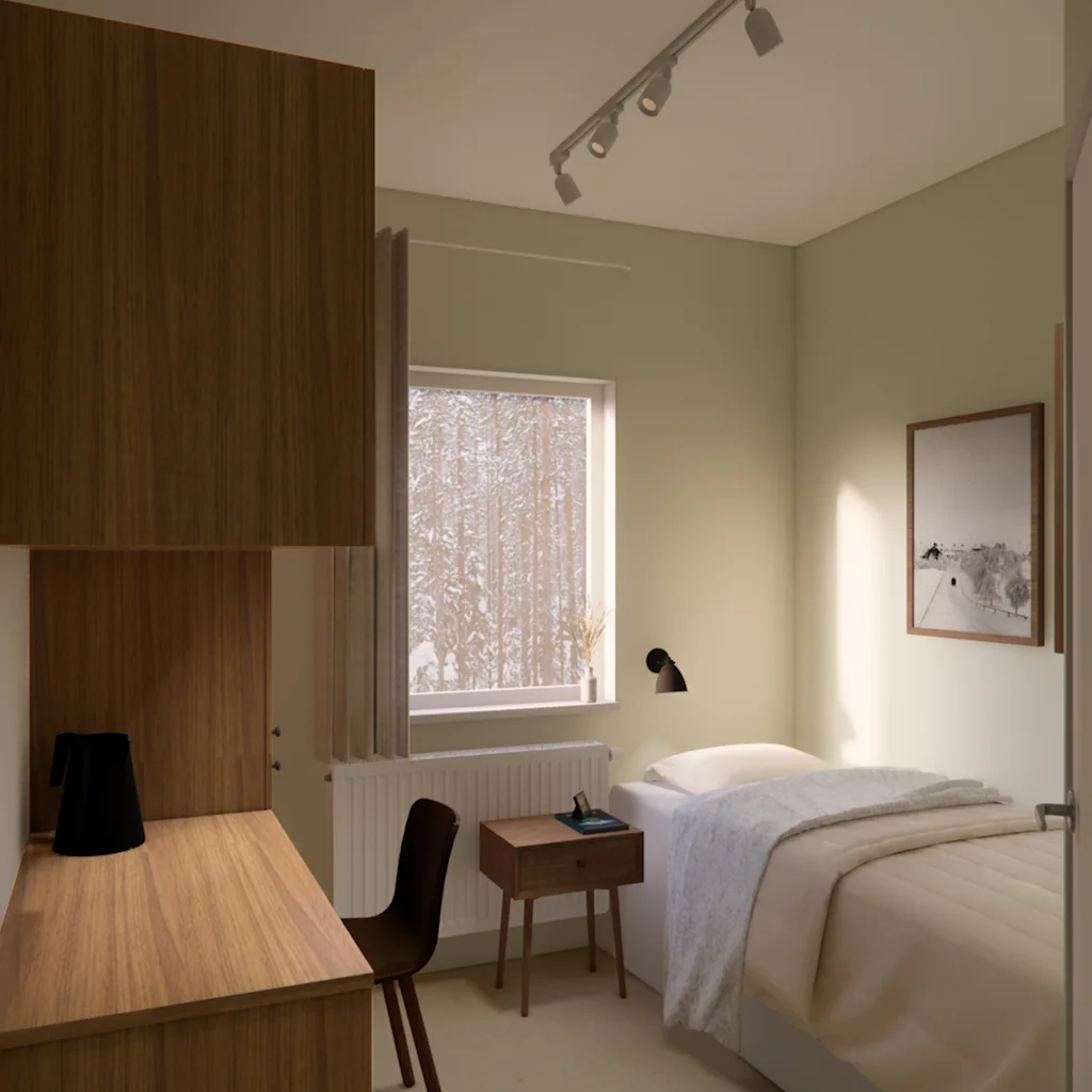 A cozy bedroom with a bed, a desk, and a window overlooking a snowy forest, perfect for a peaceful retreat.