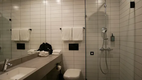A clean and modern bathroom at Comfort Hotel Norrköping with a spacious vanity, toilet, and a walk-in shower.