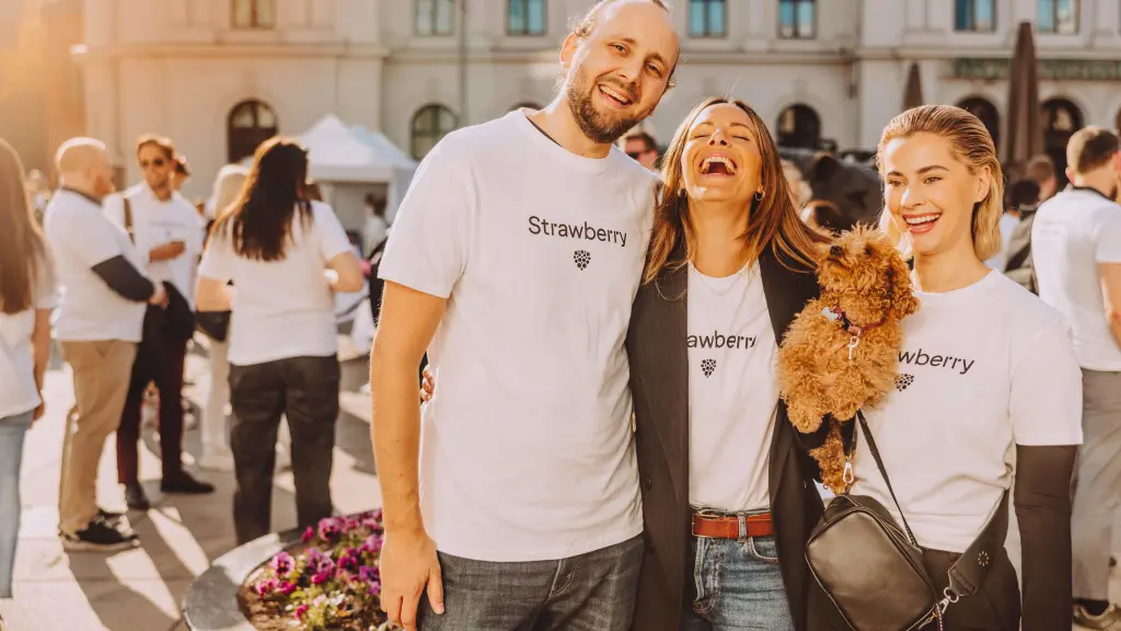 People smiling with strawberry t-shirts on.