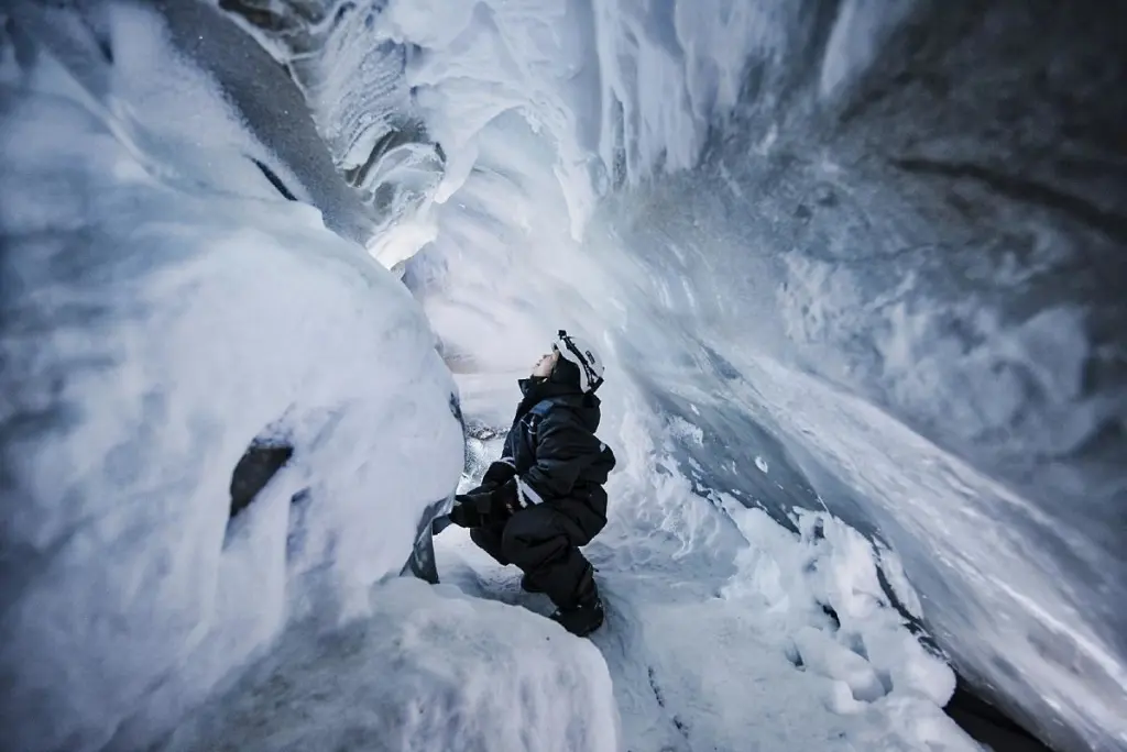 Woman in ice cave on Svalbard