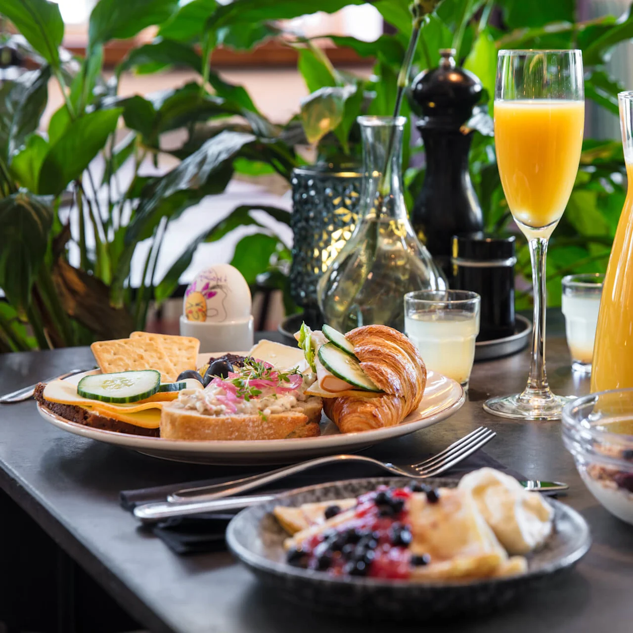 A variety of breakfast foods and beverages elegantly arranged on a table, conveying a sense of a luxurious brunch.