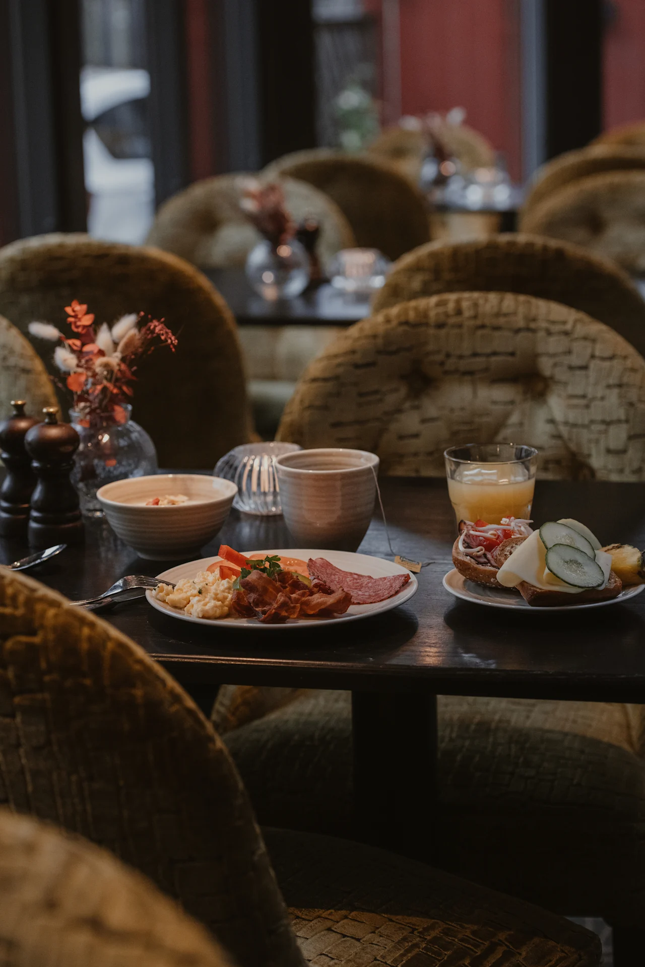 A table laden with a tempting breakfast, including savory and sweet options, at Home Hotel Kung Oscar.