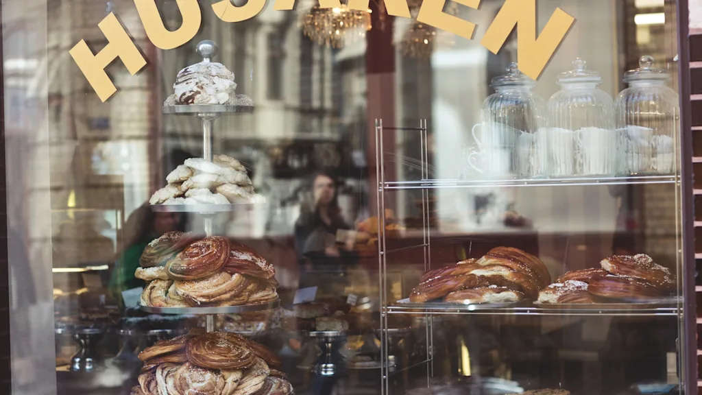 Different pastries on display in a window at Café Husaren in Gothenburg - a great meeting break activity 