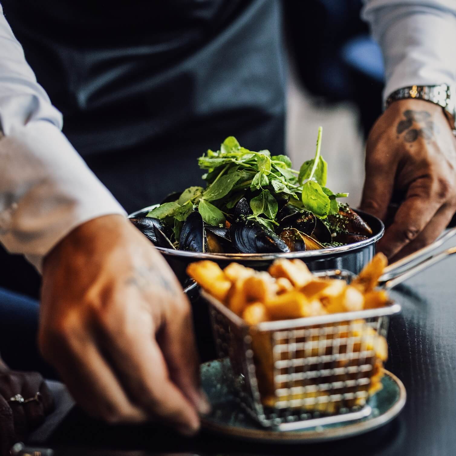 Fries and mussles being served at restaurant The Social Bar & Bistro.