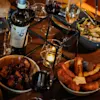 A cozy dinner spread at Comfort Hotel Arlanda Airport Terminal with wine, salad, and delicious appetizers.
