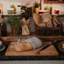 A rustic bread station with fresh loaves, pastries, butter, olive oil, and herbs, ready for a delicious meal.