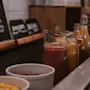 A buffet with pitchers of colorful juices and fruit. Chalkboards display juice flavors such as banana, raspberry, orange, and mango.