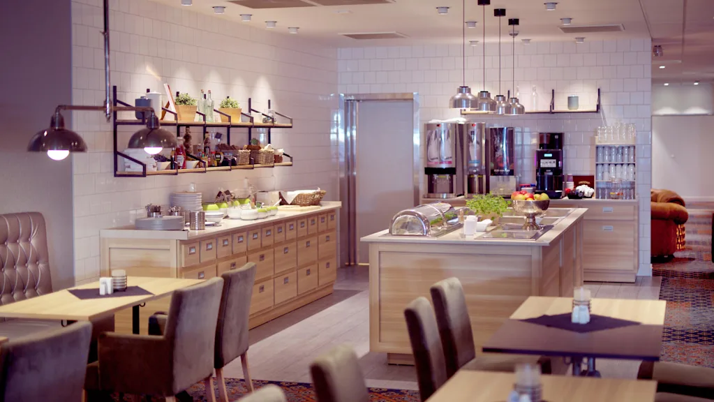 Modernt hotellbuffé med ordnade matbord, matstationer och samtida belysning i en inbjudande miljö.