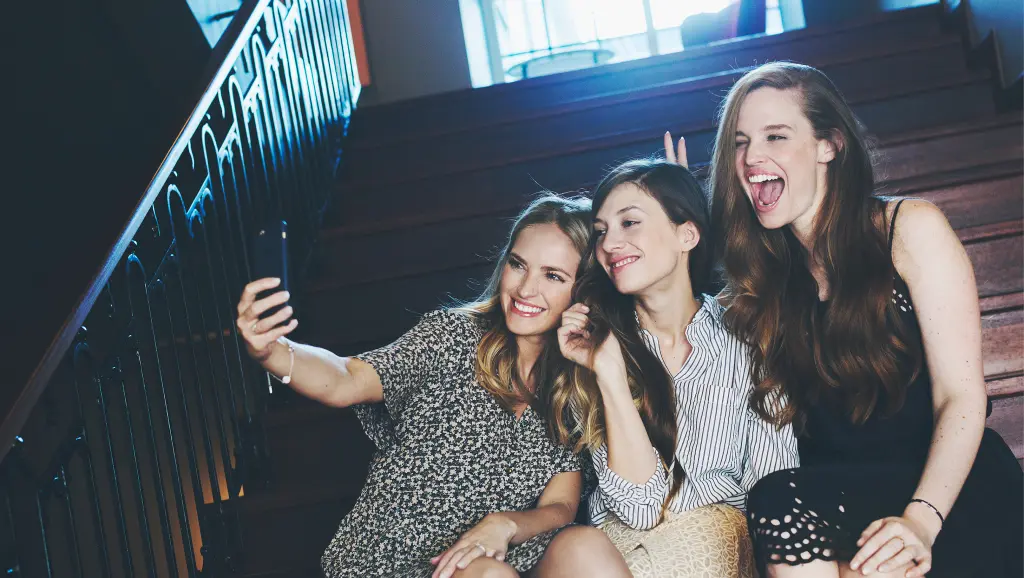 Three women taking a selfie in the stairs