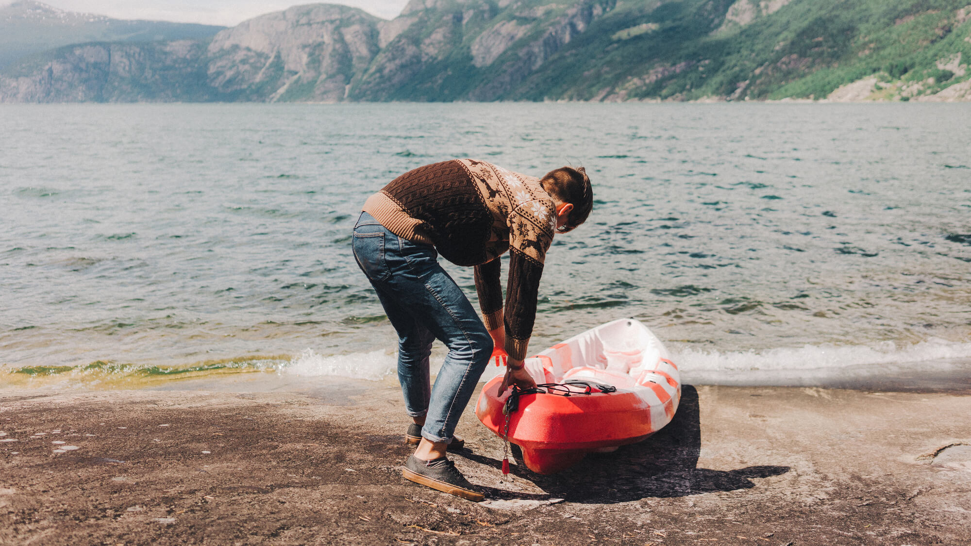 Man puts a canoe into the water