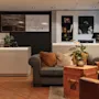 A welcoming hotel lobby featuring a reception desk and a cozy seating area, with 'TROMSO' displayed prominently on the wall.