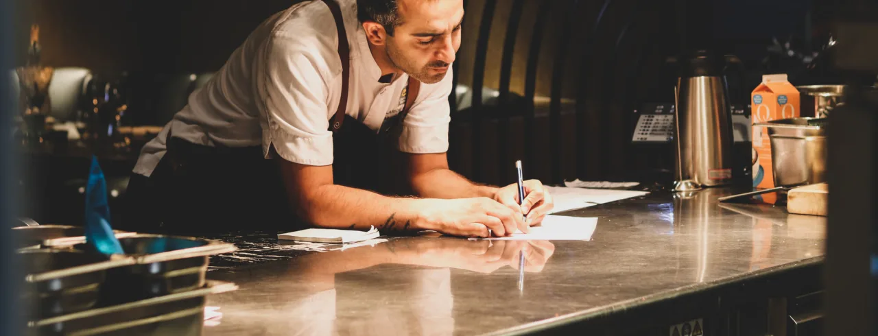 Chef taking order at restaurant in Oslo.