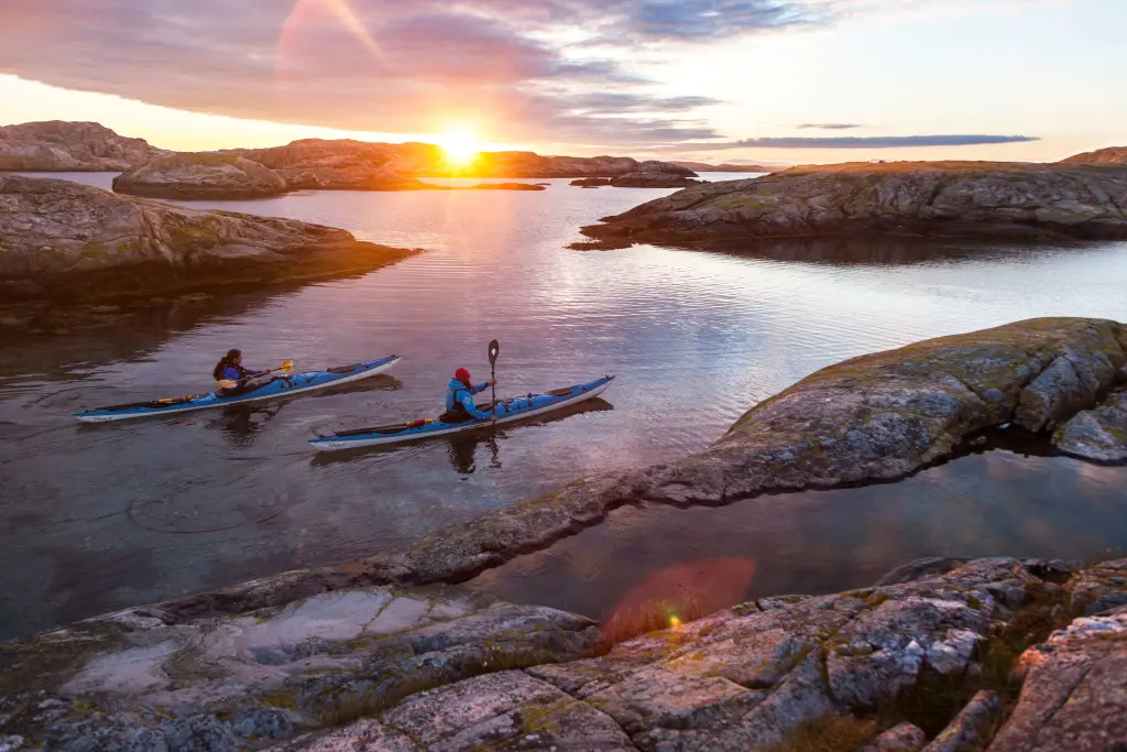 Two people kayaking in the sunset