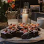 Home Hotel Kung Oscar. Delicious brownies with strawberry topping and a lit candle create a warm, inviting dessert scene.