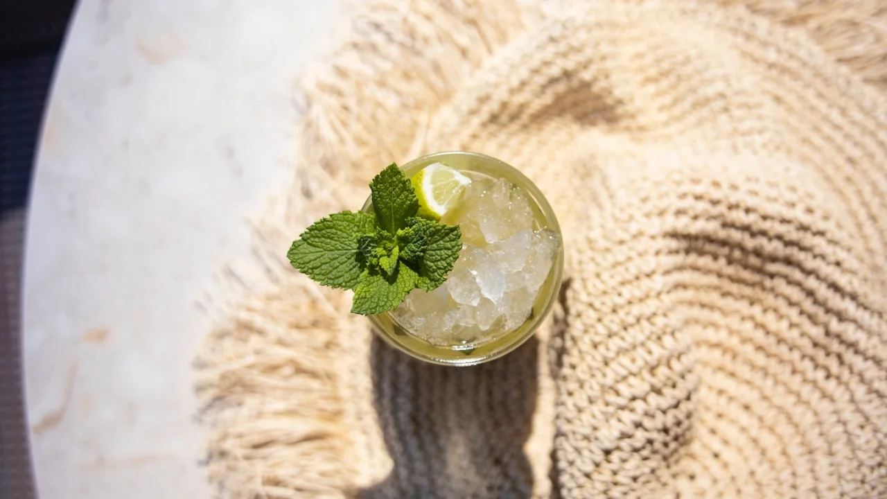 A green cocktail and a straw sun hat at Hotel Riviera in Moss, Norway.