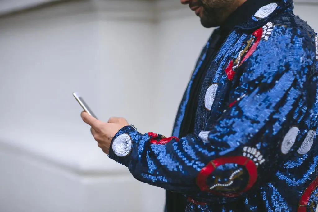 Man in glitter jacket with phone for Nordic Choice Club