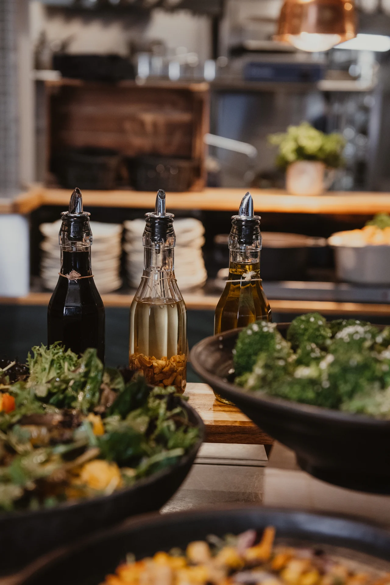 Home Hotel Uppsala offers a fresh salad bar with various dressings, including oil and vinegar, alongside healthy broccoli.