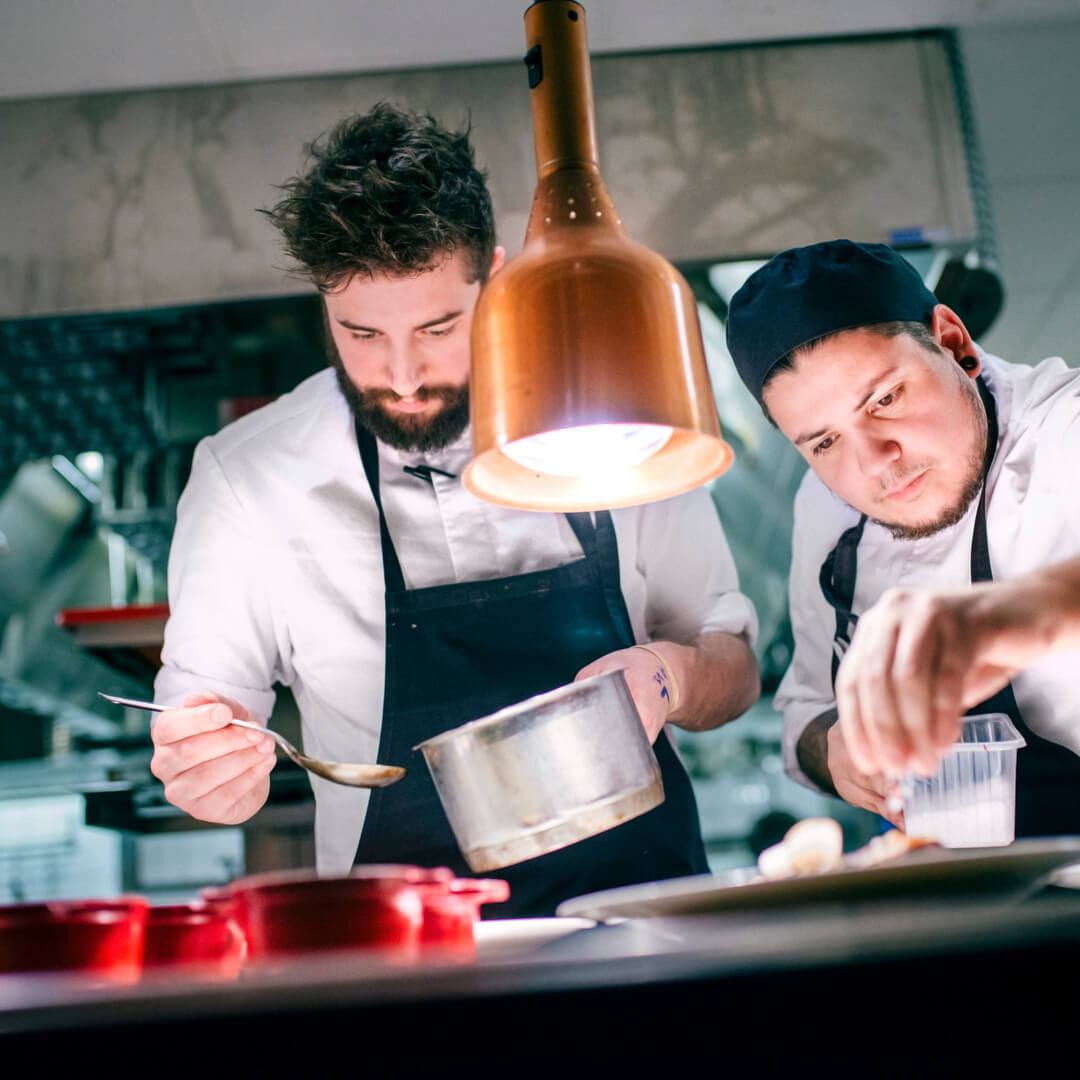 Two chefs plating at Restaurant Niesti at Copperhil Mountain Lodge in Åre.