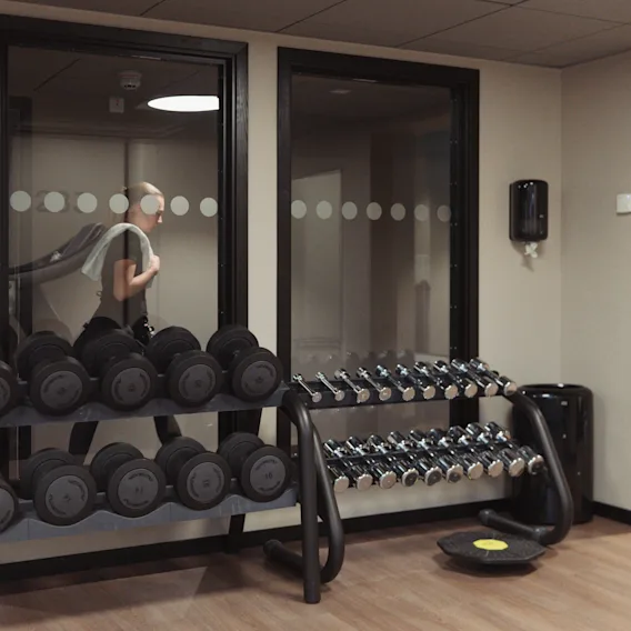 A person working out on a treadmill in the modern gym at Clarion Hotel Winn.