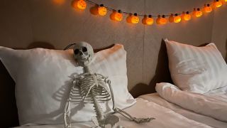 Skeleton in hotel bed