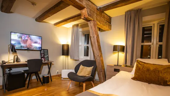 Home Hotel Bryggeparken, compact singleroom with workspace and chair.  
