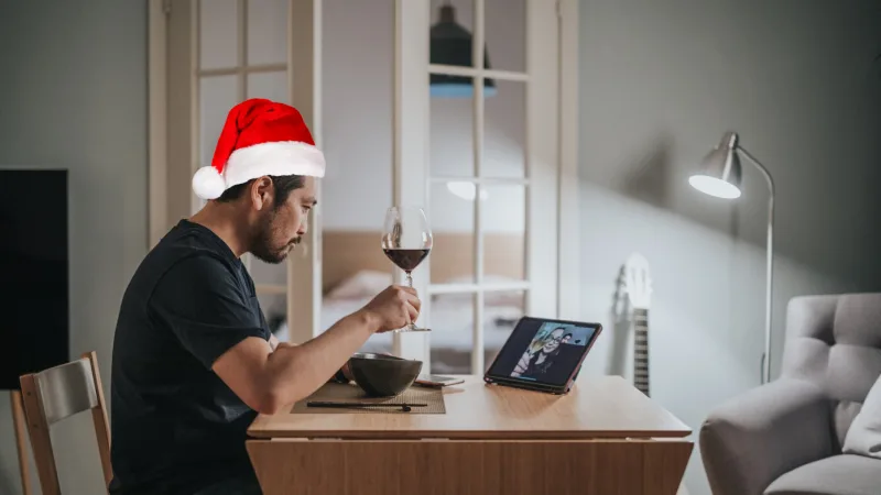 Man with santa hat on a virtual date.